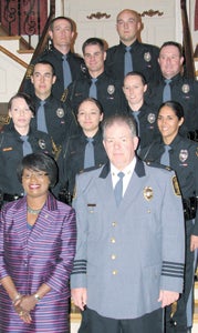 New Suffolk police officers Wilbur Dowd, Daniel Ferster, Christina Jaramillo, Elizabeth Kresse, Kelly Kuhns, Daniel Nesbitt, Amanda Sauer, Bruce Walker and Michael Wingate pose for a photo with City Manager Selena Cuffee-Glenn and Police Chief Thomas Bennett after their badge-pinning ceremony on Wednesday.