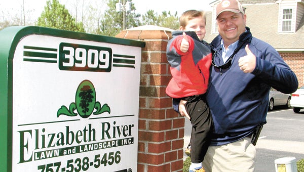 Elizabeth River Landscape Management owner Jason Fawcett and his son Owen celebrate the business being named the Suffolk Small Business of the Year by the Hampton Roads Chamber of Commerce.