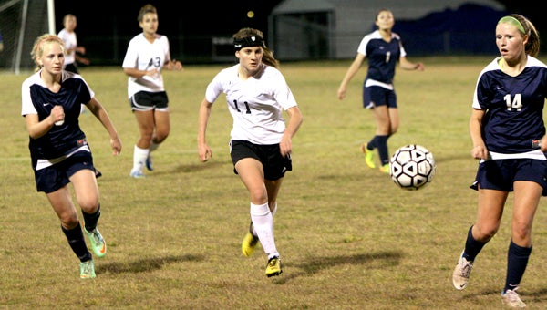 Nansemond River High School's Kendall Webster, center, pursues the ball in the second half of Thursday's 2-1 heart-breaking loss to visiting Western Branch High School.