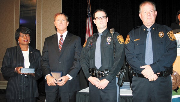 From left, Suffolk City Manager Selena Cuffee-Glenn, Hampton Roads Chamber of Commerce President and CEO Bryan K. Stephens, Suffolk Police Officer Shane Sukowaski, and Suffolk Police Chief Thomas Bennett celebrate Sukowaski’s Lifesaving Award at the 2014 Valor Awards. Officer Marc Drouillard also was honored with a Lifesaving Award but was unable to attend.