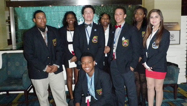 Nansemond River High School marketing education students Shedrick Roberts, Chelsea Whitney, Brandon Sargent, Bre’Aunna Rush, Frank Malcom, DuTaliya Saunders, Tala Hughes and, kneeling, Diantre Morris, participated in the Virginia DECA State Leadership Conference, where Hughes was a Top 10 Overall Winner in the job interview section.