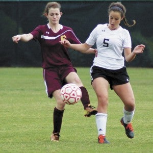 King's Fork High School sophomore Emma Marston, left, and Nansemond River High School sophomore Cali Valdivieso compete during Friday's tight conference tournament championship game at Christopher Newport University. The Lady Warriors earned the win, 3-2. (Carolina LaMagna photo)