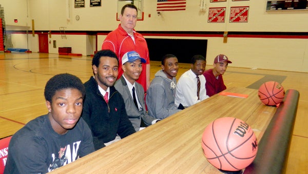 Six seniors from Nansemond River High School's basketball team announced their plans on Friday. Front row, from left: Jalen Warren, Adrian Coleman, Devon Oakley, Marvin Branch, Adrian Drew and Jalen Ruffin; in back, coach Ed Young.