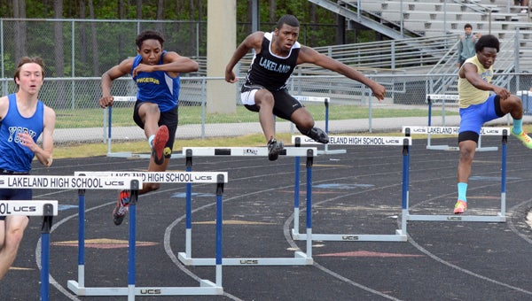 Lakeland senior Antonio Boone flies through the air in the 300-meter hurdles during Saturday’s Suffolk Invitational at Lakeland High School. He finished with a 43.27-second time. (Melissa Glover photo)