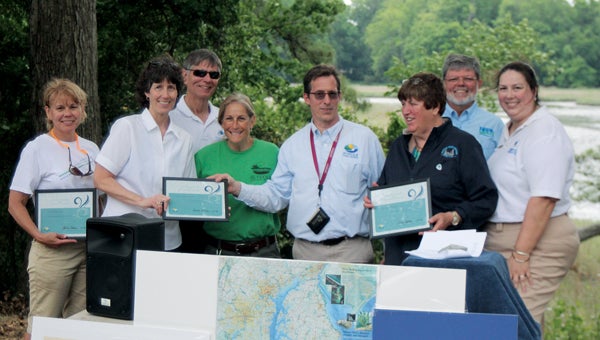During the unveiling of a national water trail kiosk at Bennett’s Creek on Saturday, Elizabeth Taraski of the Nansemond River Preservation Alliance, Ursula Lemanski and John Davy of the National Park Service, Helen Gabriel and Mike Kelly of Suffolk Parks and Recreation, Karla Smith of Suffolk River Heritage, John Wass of the alliance and Christine Lucero of the service stand with a map of the trail. (MATTHEW A. WARD/SUFFOLK NEWS-HERALD)