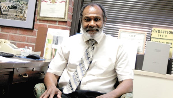 In his office Monday at Norfolk State University, Associate Professor of Mathematics Archie W. Earl, a Suffolk native, reflects on his long service to Virginia, which the state has honored with a service award.