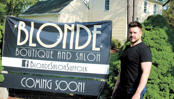 Rocky Pokorny stands outside the old house near the corner of Bridge and Shoulders Hill roads, for which he has big plans. Blonde Boutique and Salon is targeted for a June opening, he said.