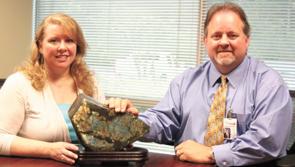 At Reed Integration in Harbour View, Becky Reed and Steve Waddell sit either side of a piece of labradorite inside the ROCK — the Results Oriented Center for Knowledge.