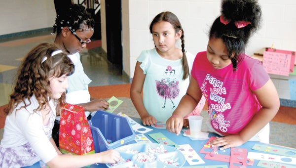 Kadience Jones, Donna Pierre, Haylee Bergerlo and Chandira James join in a craft activity during Hillpoint Elementary School’s Economics Fair Tuesday.