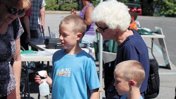 Nathan Legg, 9, and his brother Tucker, 7, along with great-grandmother Kitty Fay, enjoy one of many education displays at last year’s annual River and Creek Fest. This year’s event will be held at Bennett’s Creek Park Saturday.