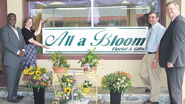 Jodi and Brian Cobb, owners of All a Bloom Florist and Gifts, show off some of their products at a Wednesday ribbon cutting with Vice Mayor Charles Brown, far left, and Councilman Charles Parr, far right.