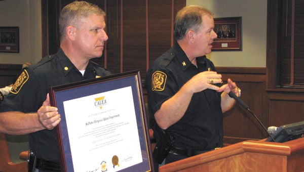 Suffolk Police Chief Thomas Bennett, right, gives a presentation at Wednesday’s City Council meeting as Maj. Dean Smith holds a certificate confirming the police department’s accreditation by the Commission on Accreditation for Law Enforcement Agencies.