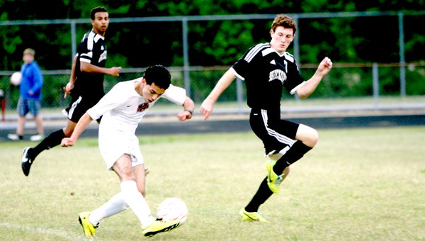 Nansemond River High School sophomore Brayan Morales fires off a shot during the Warriors' last-minute 3-2 home loss to Hickory High School on Wednesday.