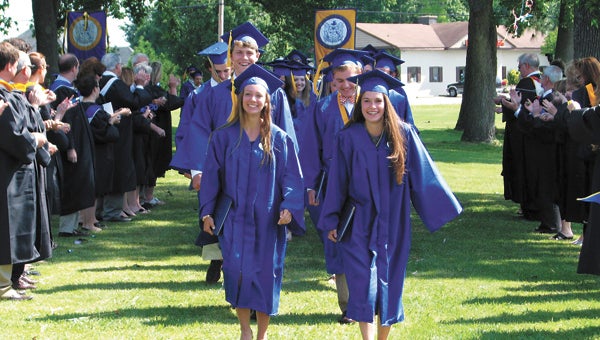 The Nansemond-Suffolk Academy class of 2014 marches past a line of faculty after their graduation at the school on Saturday.