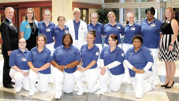 Congratulating students who successfully completed the nurse aide program are Paul D. Camp Community College President Paul Conco and instructors Courtney Darden, second from left, and Dana Stallings, right. Kneeling from left are Jessica Brienza of Franklin, Brittany Salmon of Suffolk, Whitney Coles of Suffolk, Kayla Holland of Suffolk, Emilee Eaton of Windsor, and Jacqueline Peebles of Suffolk; in the back, from left, are Brittany Johnson of Courtland, Jessica Edwards of Franklin, Sue Walton of Sedley, Alexis Blankenship of Windsor, Lori McNair of Franklin, Miranda Tillett of Franklin and Shakeyta Wood of Franklin.