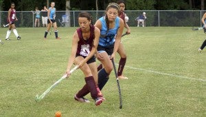 King's Fork High School's Randi Fiel, left, competes in the girls' field hockey summer league against Western Branch High School's Riley Greenwood on Monday at Lakeland High School.