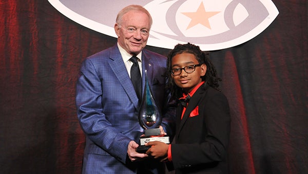 Select company: Seventh-grader and First Team Academic All-American Tristan Jolley of the Bennett's Creek Warriors, right, presents a Lifetime Achievement Award to Dallas Cowboys owner Jerry Jones at the recent Pop Warner Scholastic Banquet in Florida. (Photo submitted by Brian Heffron)