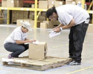 Employees from Massimo Zanetti check lists for the SKU code that matches the one on the last box on their pallet during the LogistXGames at the Ace Import Redistribution Center at CenterPoint on Friday. The company’s warehousing and distribution employees were among those from seven different area companies competing in the event, which had been held 25 times before but was visiting Virginia for the first time.