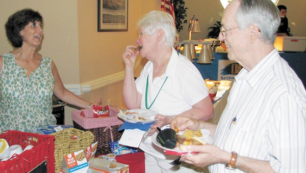 Vendor Debbie Gordon offers snack foods to Peg and Ray Cicirelli at the Lake Prince Woods food fair last Wednesday. The event was set up to allow residents and staff to sample items not currently on the menu and make recommendations for what they’d like to see in the community’s dining hall.