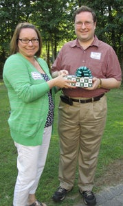 Kelly Holdcraft, director of alumni engagement for the College of William and Mary Alumni Association, presents the Young Alumni Service Award to Jeremy Utt, president of the South of the James Alumni Chapter at its annual picnic on June 1.
