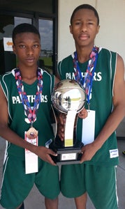 Thirteen-year-olds Lamareon James and Leontre Bailey formed a potent backcourt that  helped the seventh-grade Virginia Panthers Academic Basketball Club place among the top five teams in the country at the recent 2014 AAU Boys' Basketball National Championship in Memphis, Tenn. They hold the trophy that the team earned for its fifth-place finish. (Photo submitted by Darius Bailey)