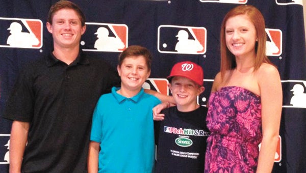 Ten-year-old Clay Grady of Suffolk, second from right, competed in the National Finals of the 2014 Major League Baseball Pitch, Hit and Run program on Monday. He is pictured with his oldest brother, Jake Grady, on the far left, his brother Ben Grady and sister Ginna Grady, taken before a reception dinner held Sunday night.