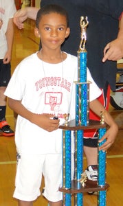 Creekside Elementary School rising third-grader Karem Robinson wraps an arm around his Camper of the Week trophy that nearly matches him in height. He received the award on Thursday at the conclusion of the 10th annual Youngstarz Basketball Camp at Nansemond River High School.