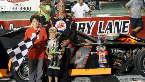 Robbie Babb celebrates with trophy presenters following his twin wins in the 30-lap Modifieds events, the main feature races of the NASCAR Whelen All-American Series at Langley Speedway on Saturday. (Bill Carr/MotorSports Photo News Service)