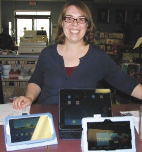 Kristen Marshall, support services manager at Morgan Memorial Library, shows off tablet devices available for library patrons to try.
