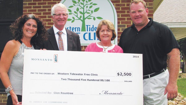 Agricultural company Monsanto donated $2,500 to the Western Tidewater Free Clinic last week. From left are clinic Director of Development Ashley Greene, local farmer Rex Alphin, clinic Executive Director Miriam Beiler and Monsanto District Sales Manager Glenn Rountree.