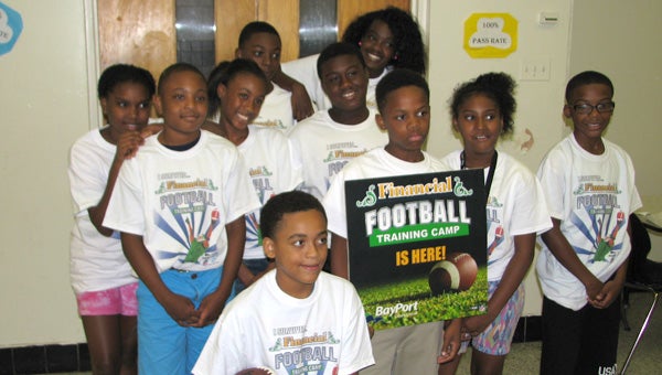 The financial football team from the Boys and Girls Club Suffolk Unit celebrates on Friday. The team competed against a unit from Portsmouth in the game, a program by Bayport Credit Union.