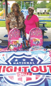 Beulah Hall and Arleathia Crocker, publicist and secretary, respectively, of the Lake Kennedy Civic League, show off some of the bookbags the civic league will give away to children in attendance at the community’s National Night Out celebration on Aug. 5.