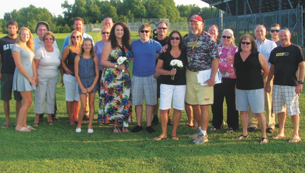 Joe and Sandy Jones and their family celebrate their vow renewal on the football field at King’s Fork High School on Tuesday. Joe Jones is the football coach at the school.
