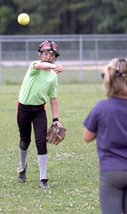 Eleven-year-old Emily Mandara of Smithfield throws to her 8-year-old sister Maggie on Thursday during a camp administered by Ozzie Smith's Sports Academy at the SYAA Complex. The sisters were the only softball campers.