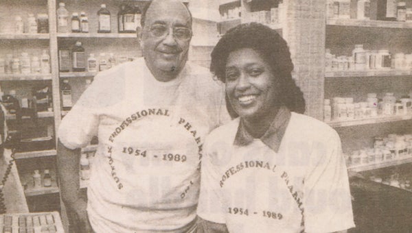 At the 60th anniversary of Suffolk Professional Pharmacy’s opening, Patricia Richards-Spruill, pictured above in the Suffolk News-Herald in 1989 with her father, James E. Richards Sr., hopes to do something special to honor her father.