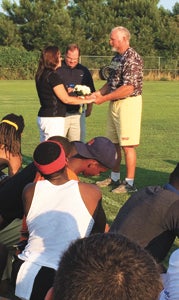 oe and Sandy Jones renew their vows on the football field at King’s Fork High School on Tuesday. Joe Jones, the football coach at the school, got his entire team in on the ceremony.