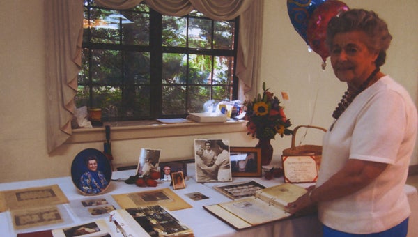 Marjorie Wilkinson shows off the memory table at her 90th birthday celebration.