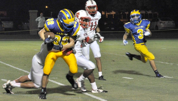 Nansemond-Suffolk Academy junior running back Reed Browne pushes for more yardage late during the Saints' 66-32 season-opening win over visiting North Cross School on Friday night.