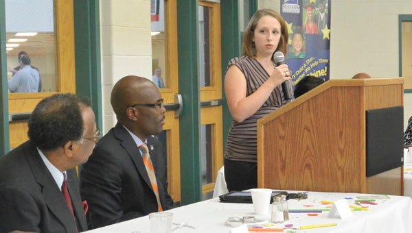 Suzanna Hodges, Suffolk Public Schools’ Rookie Teacher of the Year last year, gives words of encouragement to this year’s crop of rookies at a welcome breakfast for new teachers on Monday. Listening in are Superintendent Deran Whitney, center, and School Board member Enoch C. Copeland.