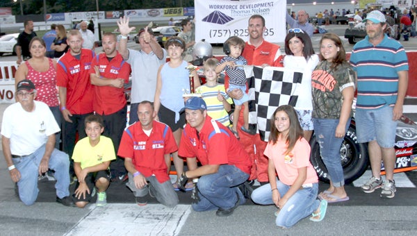 Greg Edwards with family, crew and car owner James Long holding up #6  after Greg’s first Twin 75 Lap Feature win for the Comserve/Verizon Wireless Late Model Stock Cars in  the “4CDL.com/Thomas Nelson Community College Night At The Races” at NASCAR Whelen All-American Series events of 8/9/14 at Langley Speedway. (Bill Carr/MotorSports Photo News Service)