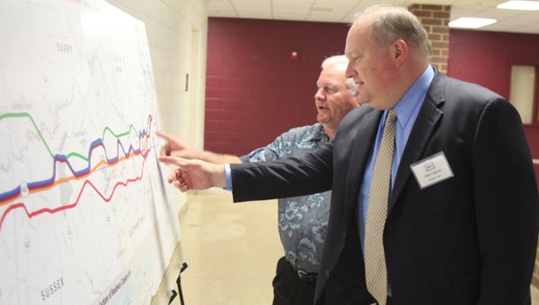 Presentation: During a public meeting on the Route 460 project, held at King’s Fork High School on Thursday, Suffolk’s Alvin Anderson Jr. and Mike Tugman, a consultant project manager with VDOT, review design alternatives for improving the road between Suffolk and Petersburg. 