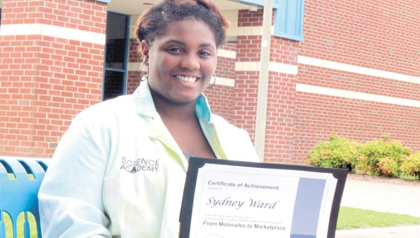 Rising Lakeland High School senior Sydney Ward wears the lab coat she tie-dyed during a summer science program in New Jersey last month, as well as the certificate students received after the BASF Science Academy.