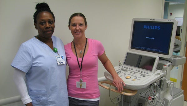 Erika Elliott, left, an LPN at CHKD’s Harbour View North, and Leslie Stratchko, a cardiac sonographer, show off a cardiac ultrasound machine at the new office on Thursday.