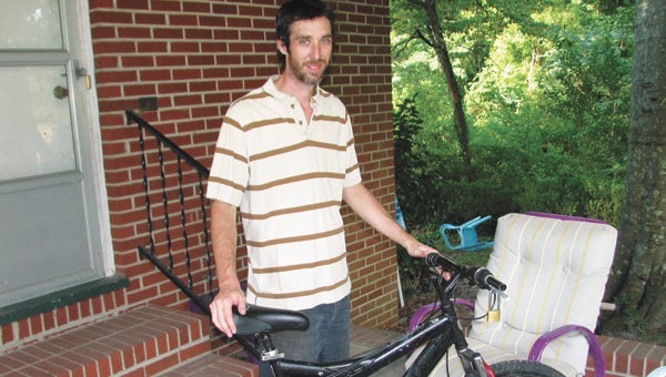 Lee Langston shows off the bicycle he got back damaged after it was stolen by local teens. He says there has been a rash of such thefts lately in his area.