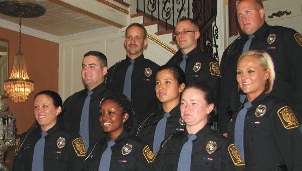 New Suffolk police officers pose for photos after their badge-pinning ceremony on Friday. The new officers are Haley Brock, John Christmas, Meredith Fetter, Kristi Gaines, Robert Gazsy, Jennifer Parker, Jerad Price, Casey Shreve and Latifah Whitfield.