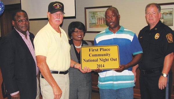 Representatives of the West End Civic League accept a plaque from city officials naming them the top community in Suffolk’s National Night Out at a Tuesday event. From left are Vice Mayor Charles Brown, civic league President Jim Strickland, City Manager Selena Cuffee-Glenn, Clarence Gamble with the civic league, and Police Chief Thomas Bennett.