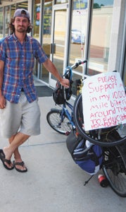 David Gower, 30, stopped at a laundromat on North Main Street on Friday, in the early stages of his quest to cycle around the circumference of the U.S. to help the homeless.