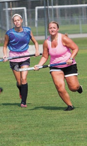 New Lakeland High School varsity field hockey coach Cortney Parker participates with her players during practice on Wednesday in preparation for the 2014 season.