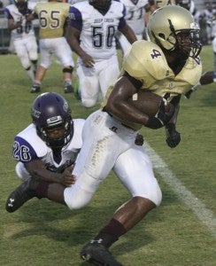 King's Fork High School junior feature back Deshaun Wethington rushes through visiting Deep Creek High School's defense for more yardage during the Bulldogs' 55-0 season-opening win on Thursday night.