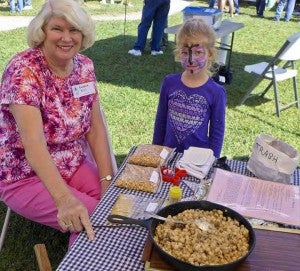 Barbara Ellis and Naomi West work at a hominy pot during the Southampton County Historical Society’s Heritage Day celebration last year. Such demonstrations are a popular part of the well-attended event each year. (Anne W. Bryant photo)